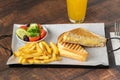 Cheddar cheese toast with french fries and salad on wooden table Royalty Free Stock Photo