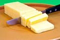 Cheddar cut into blocks on a brown plate. Royalty Free Stock Photo