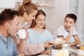 Cheeful family having meal together in the kitchen