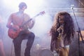 Cheeful female singer with male guitarist performing at nightclub Royalty Free Stock Photo