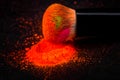 Cheek brush with neon cosmetic powder colorful pile on black background Royalty Free Stock Photo