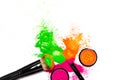 Cheek brush with neon cosmetic powder colorful pile on white background