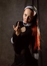 Cheeky beautiful catholic nun shows middle finger. religious concept