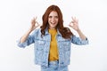 Cheeky good-looking redhead girl in denim jacket, yellow t-shirt, assuring everything excellent, say well done, looking