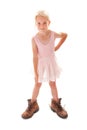 Cheeky young blonde girl dressing up in ballet outfit and Dad`s big walking boots