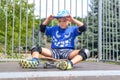 Cheeky young boy sitting on his skateboard Royalty Free Stock Photo