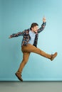 Cheer, joy. Young happy bearded man in casual clothes jumping isolated on light blue background. Royalty Free Stock Photo