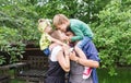 Cheerful active family of four having fun at countryside in summer day. Royalty Free Stock Photo