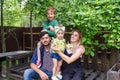 Cheerful active family of four having fun at countryside in summer day. Royalty Free Stock Photo