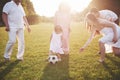 Cheerful active family having fun at countryside in summer day. Royalty Free Stock Photo