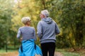 Cheerful active senior couple jogging in the park