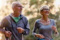 Cheerful active senior couple jogging in the park Royalty Free Stock Photo