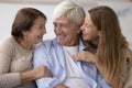 Cheerful adult daughter having fun with elder mom and dad Royalty Free Stock Photo