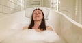 Happy woman taking foamy bath