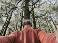 Cheerful adult happy man taking selfie picture in the woods enjoying outdoors leisure activity in national forestal park alone. Royalty Free Stock Photo