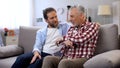 Cheerful adult males sharing memories father and son joking and having good time Royalty Free Stock Photo