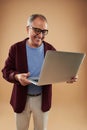 Cheerful adult man holding modern laptop and smiling Royalty Free Stock Photo