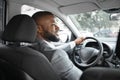 Back view of cheerful black businessman driving car Royalty Free Stock Photo