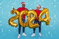 Cheerful African American Couple Holding Golden 2024 Balloons On Blue Background