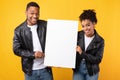 Cheerful African American Couple Showing Blank Poster Over Yellow Background Royalty Free Stock Photo