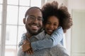 Cheerful african american family enjoying playtime indoors.