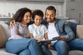 Cheerful African American Family With Little Son Reading Book Together At Home Royalty Free Stock Photo