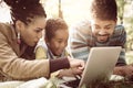 African American family lying down in park and using l Royalty Free Stock Photo