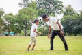 Cheerful african american father and son playing with football in park, Happiness family concepts Royalty Free Stock Photo