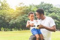 Cheerful african american father and son playing with football in park, Happiness family concepts Royalty Free Stock Photo