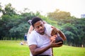 Cheerful african american father and son playing in park, Happiness family concepts, parent and child play in park Royalty Free Stock Photo