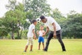 Cheerful african american father and two sons playing with football in park, Happiness family concepts Royalty Free Stock Photo