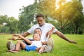 Cheerful african american father and two sons playing in park, Happiness family concepts, parent and childs play in park Royalty Free Stock Photo