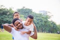 Cheerful african american father and two sons playing in park, Happiness family concepts, parent and childs play in park Royalty Free Stock Photo