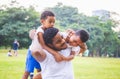 Cheerful african american father and two sons playing in park, Happiness family concepts, parent and childs play in park Royalty Free Stock Photo