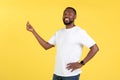 Cheerful African American Guy Clicking Fingers Standing Over Yellow Background