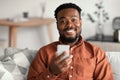 Cheerful African American Guy Using Mobile Phone At Home Royalty Free Stock Photo