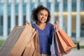Cheerful African American Lady Shopping Holding Many Paper Bags Outside