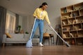 African Lady Sweeping Floor Using Broom And Scoop Cleaning Home Royalty Free Stock Photo