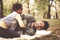 Cheerful African American little girl with her father in park pl Royalty Free Stock Photo