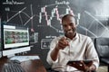 Just earn more. Cheerful african american male trader sitting by desk, pointing at camera and studying analytical Royalty Free Stock Photo