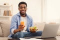Cheerful african-american man eating healthy lunch at home Royalty Free Stock Photo