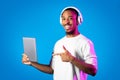 Cheerful african american man using digital pad and wireless headphones Royalty Free Stock Photo