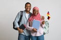 Cheerful african american muslim students couple holding german flag Royalty Free Stock Photo