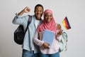 Cheerful african muslim students couple holding german flag Royalty Free Stock Photo