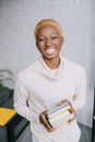 Cheerful african american woman holding books Royalty Free Stock Photo