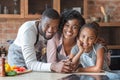 Cheerful african family spending time together at kitchen Royalty Free Stock Photo