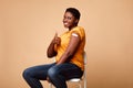 Cheerful African Female Gesturing Thumbs-Up After Antiviral Vaccine Injection, Studio