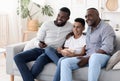 Cheerful african grandpa, father and son relaxing together in living room Royalty Free Stock Photo
