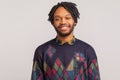 Cheerful african man in casual style sweatshirt with dreadlocks looking at camera with healthy toothy smile, satisfied with life,