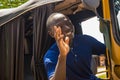 cheerful african man driving a tuk tuk taxi smiling on a very sunny day waving to a passenger Royalty Free Stock Photo